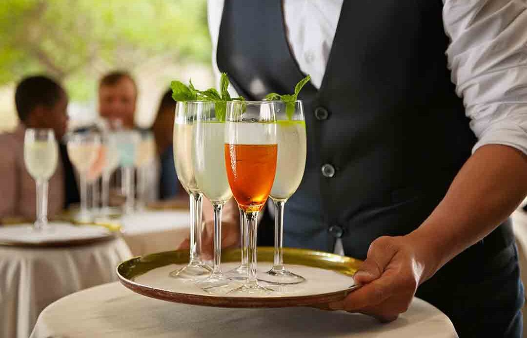 waiter serving mocktails in a restaurant